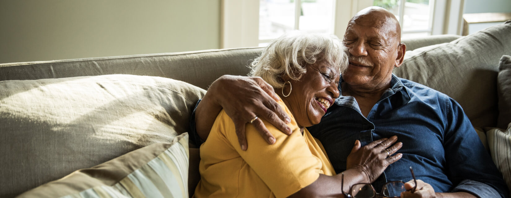 Couple cuddling on the sofa