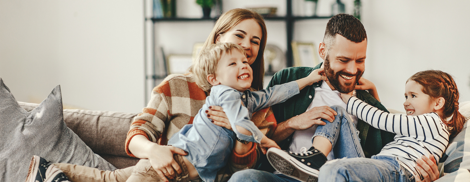 Family playing on sofa