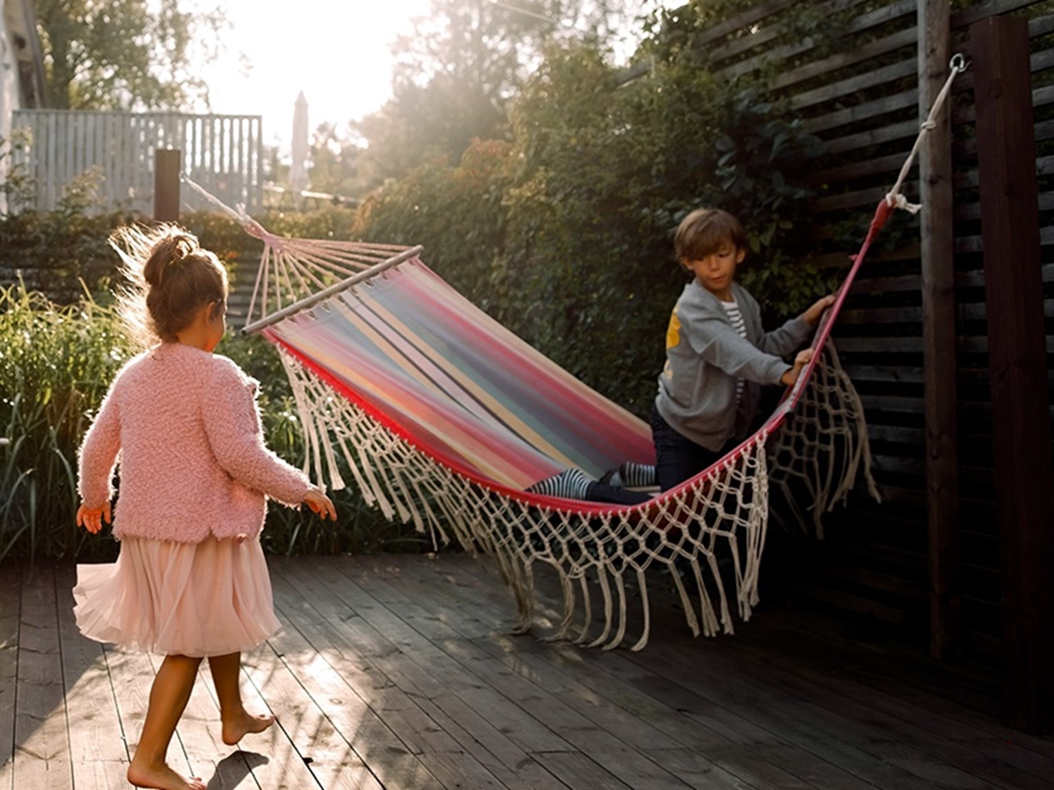 Family in the garden with a child in a hammock