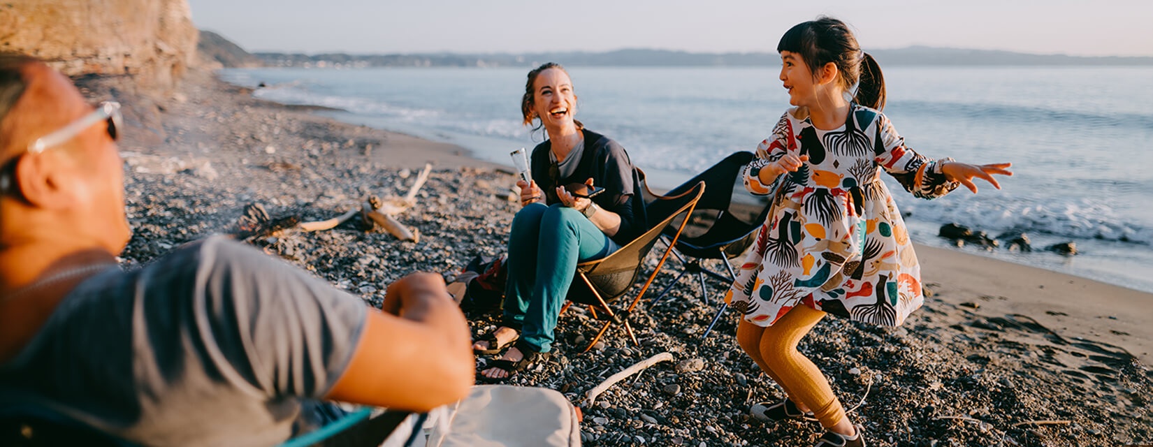 Father, mother and girl dancing in beach