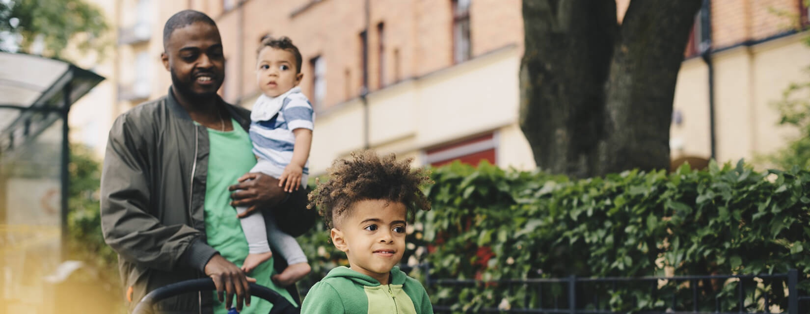 dad with two kids with pushchair