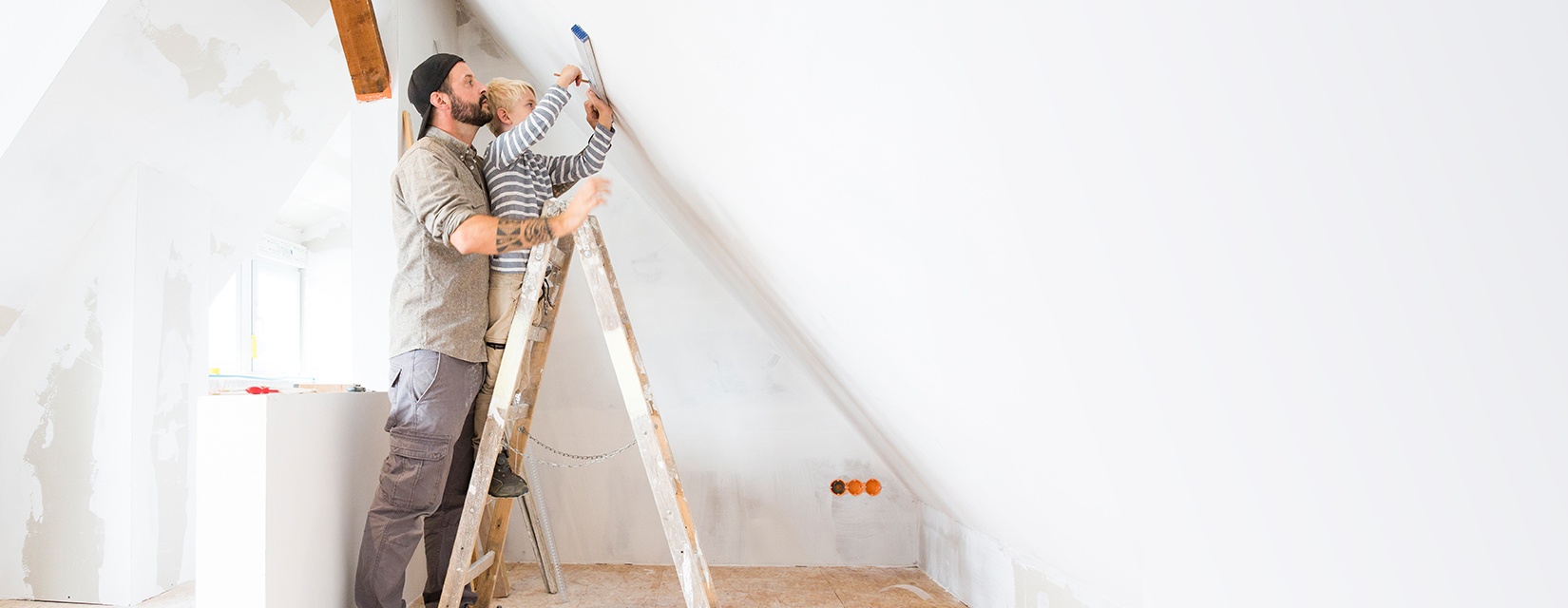 Father and son on a ladder with diy tools