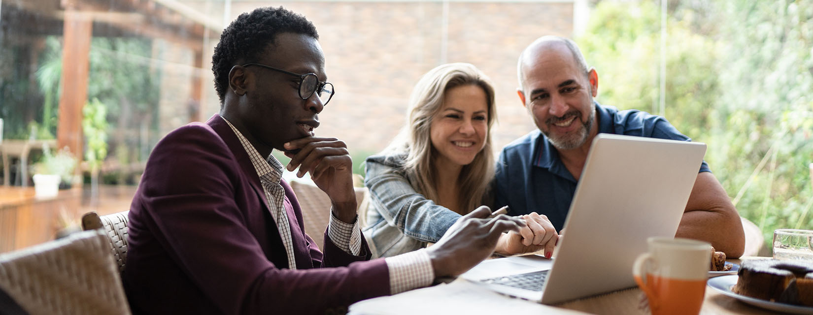Finance advisor doing a meeting with couple at home