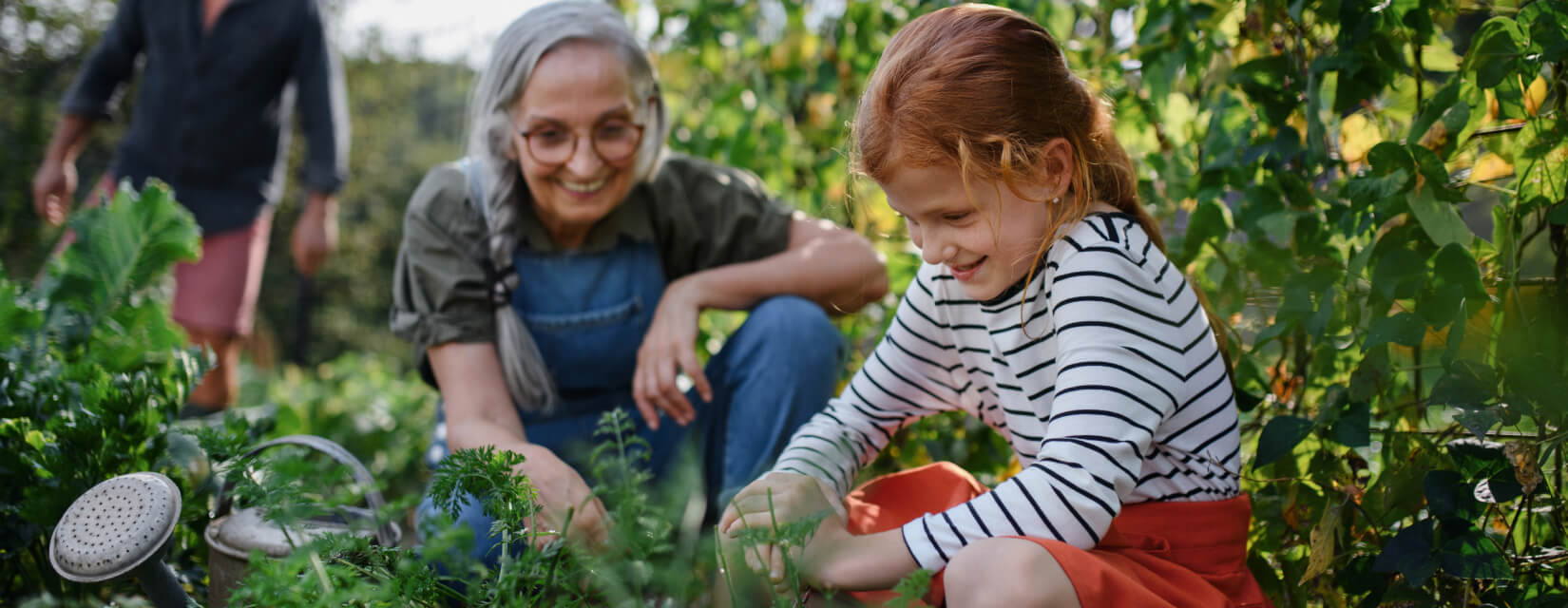 Granddaughter and grandmother doing gardening outside