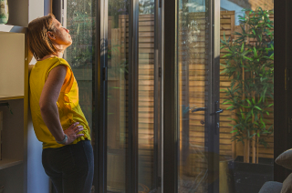 Woman staring out of a window