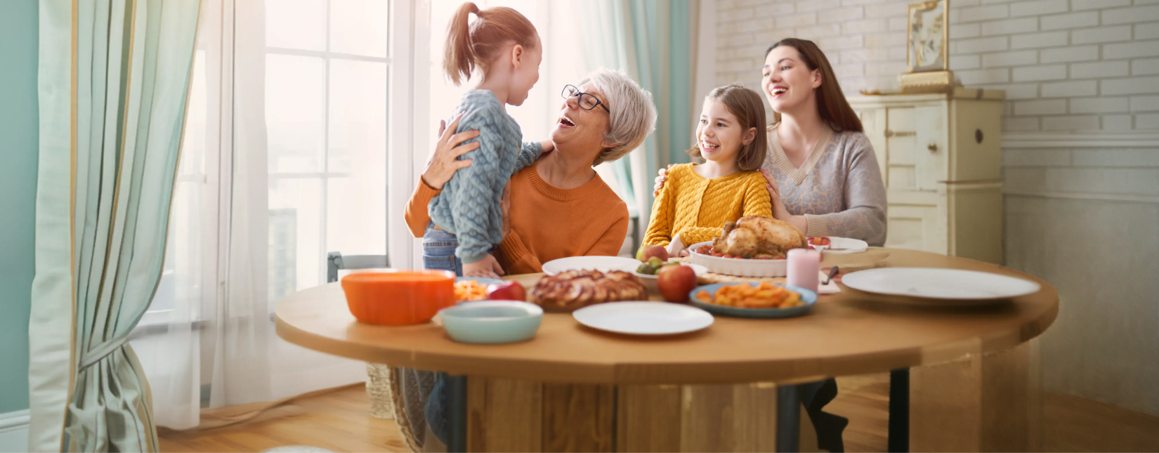Happy, multigenerational family eating breakfast