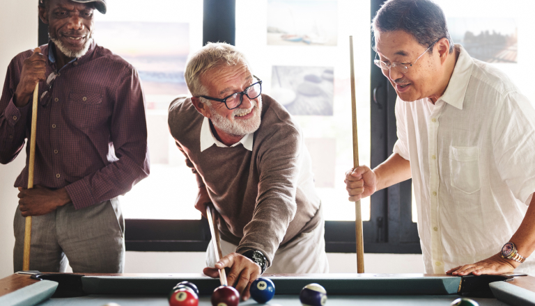 Senior men playing pool