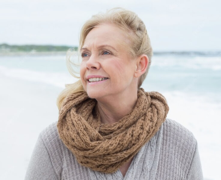 Woman at the beach on a breezy day