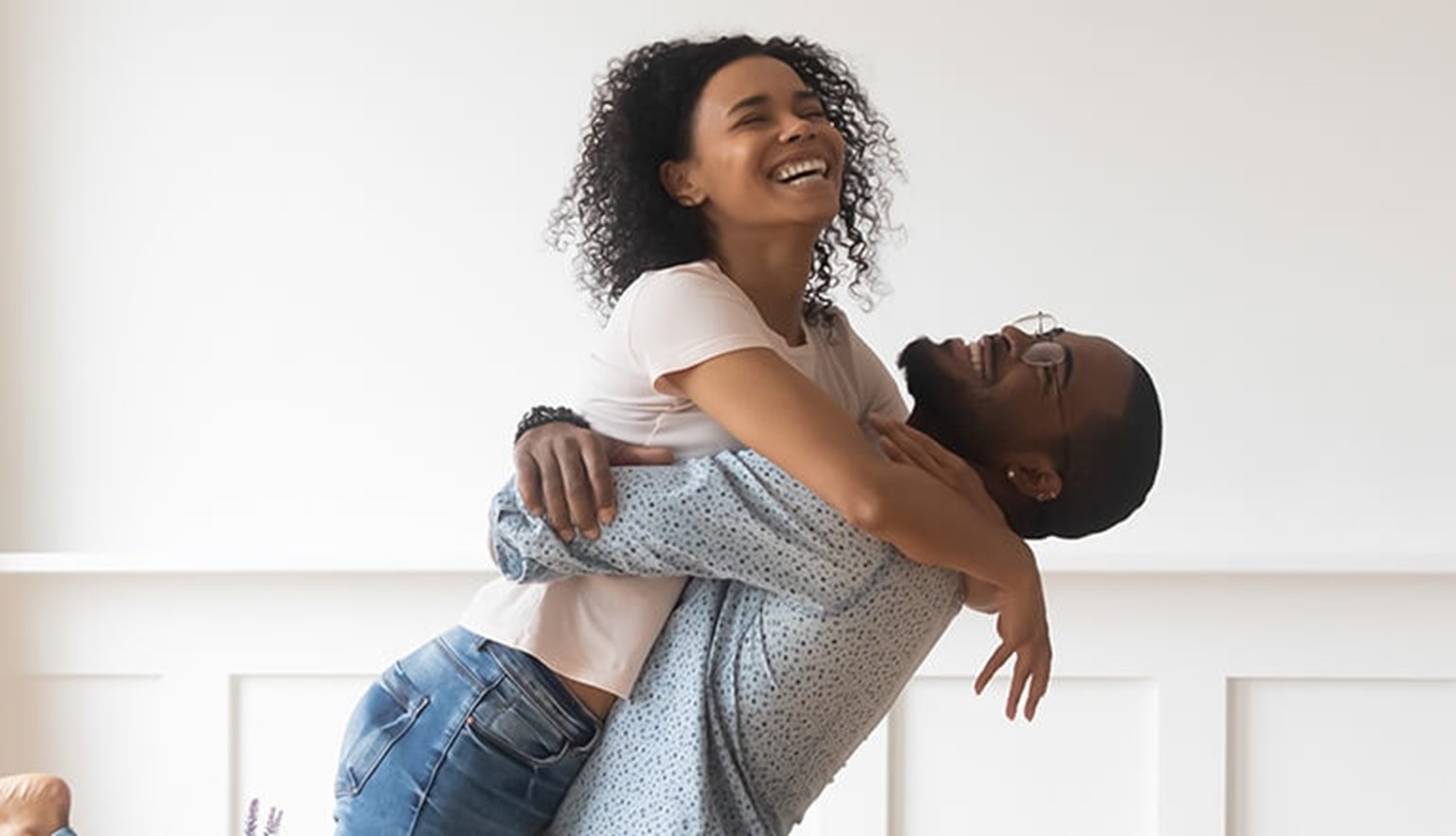 man lifting and hugging woman