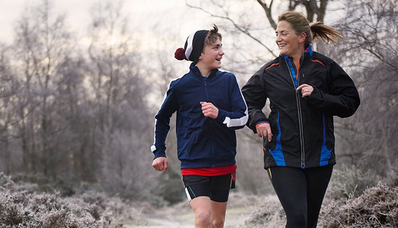 Mother and teenage son running
