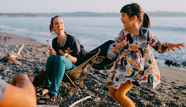 Father, mother and girl dancing in beach