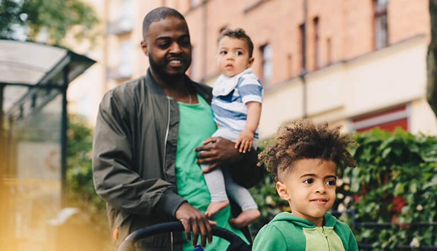 dad with two kids with pushchair