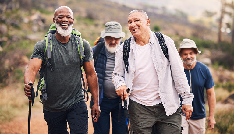 4 men smiling hiking together