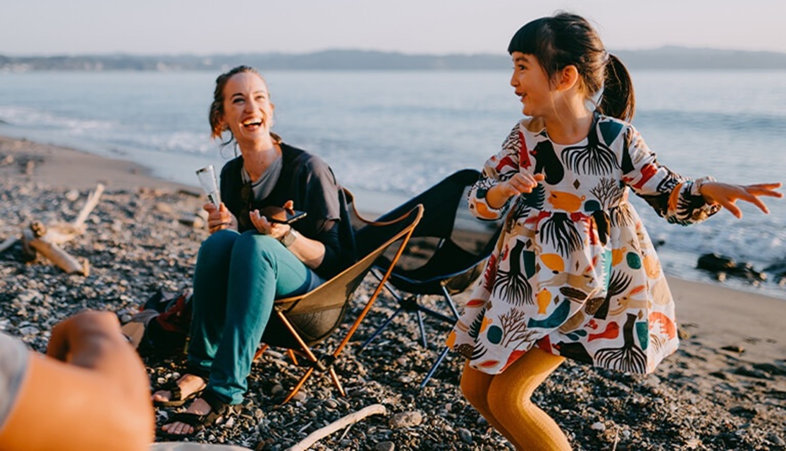 Father, mother and girl dancing in beach
