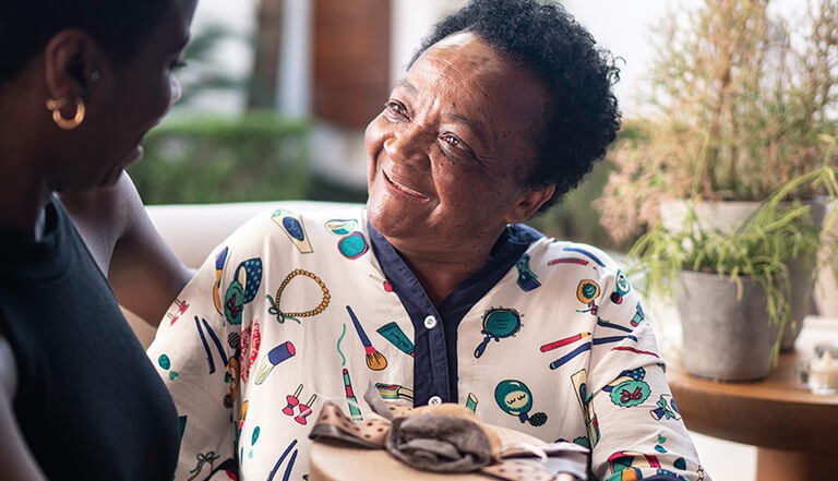 grandmother giving gift to granddaughter