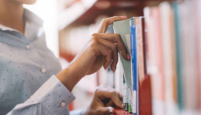 women finding out book in library