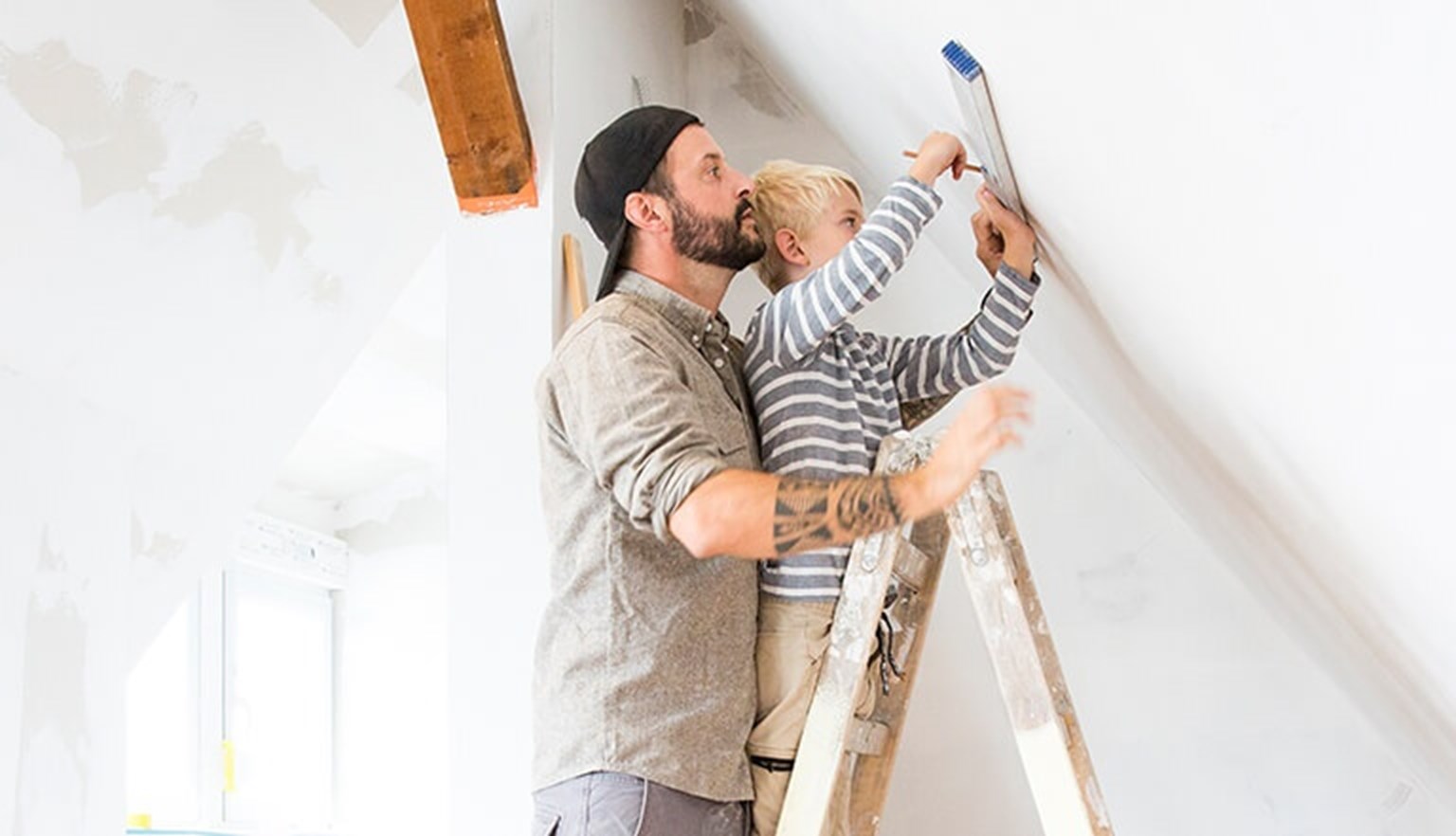 Father son standing on ladder, DIY tools
