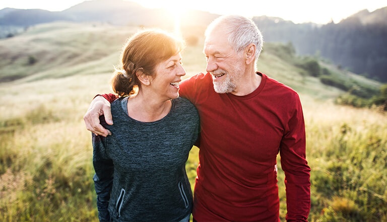 Couple walking outdoors in sunlight