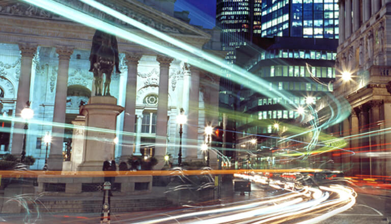 Long exposure shot of city with vehicle lights streaking across the image