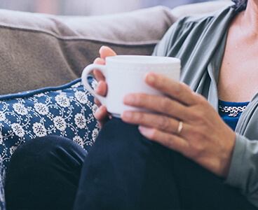woman holding mug of coffee